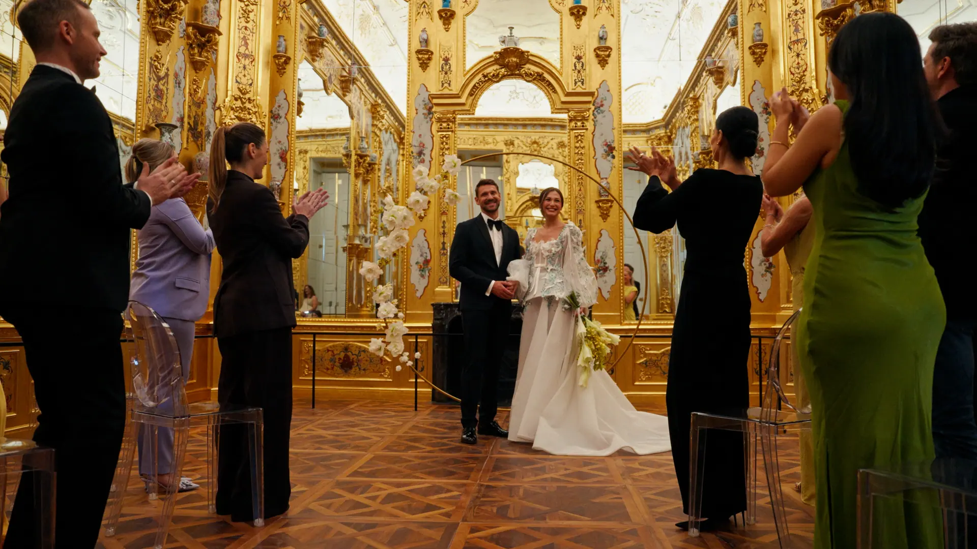 Bride and groom applauded in the gilded Marble Hall at the Belvedere