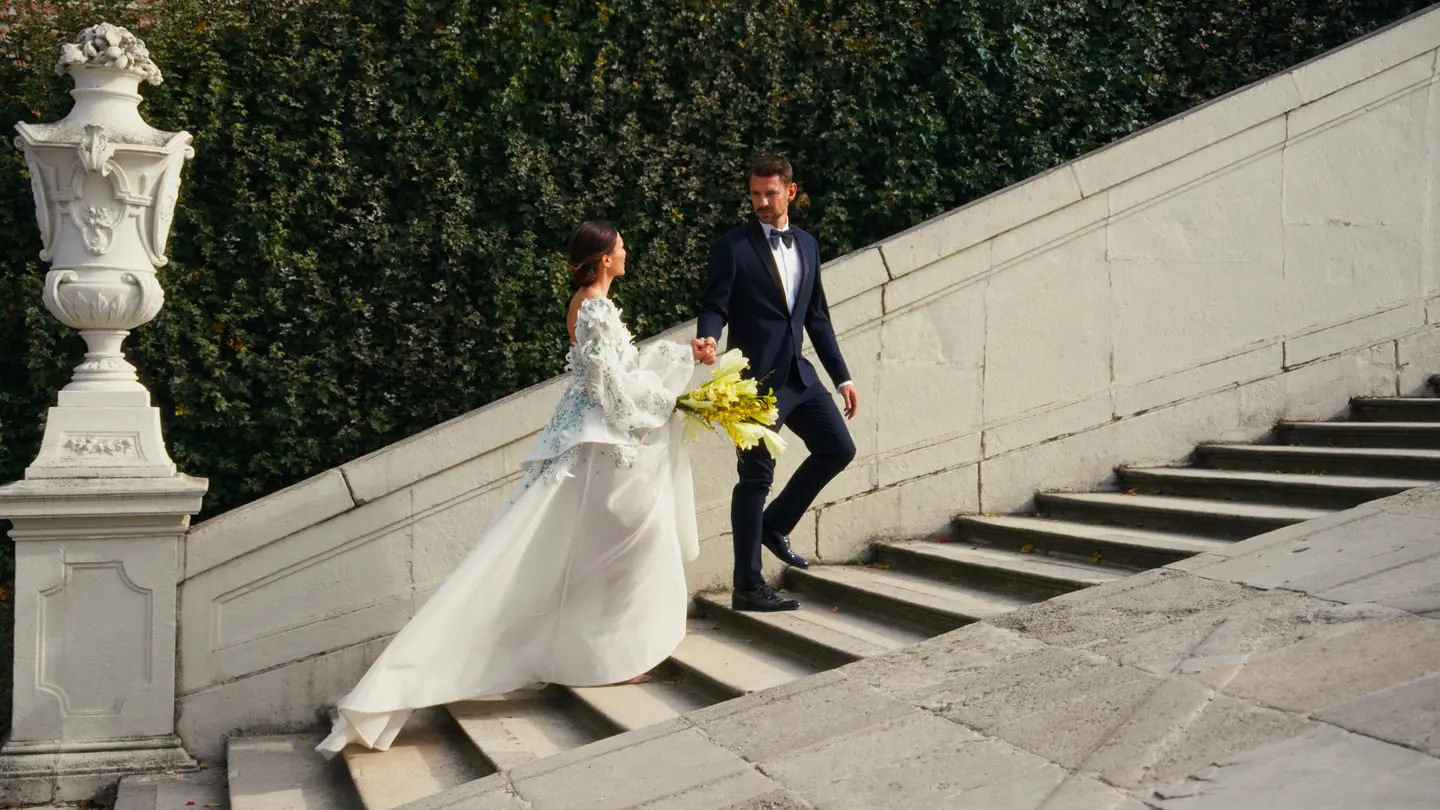 Bride and groom walking on the exterior stairs of the Belvedere