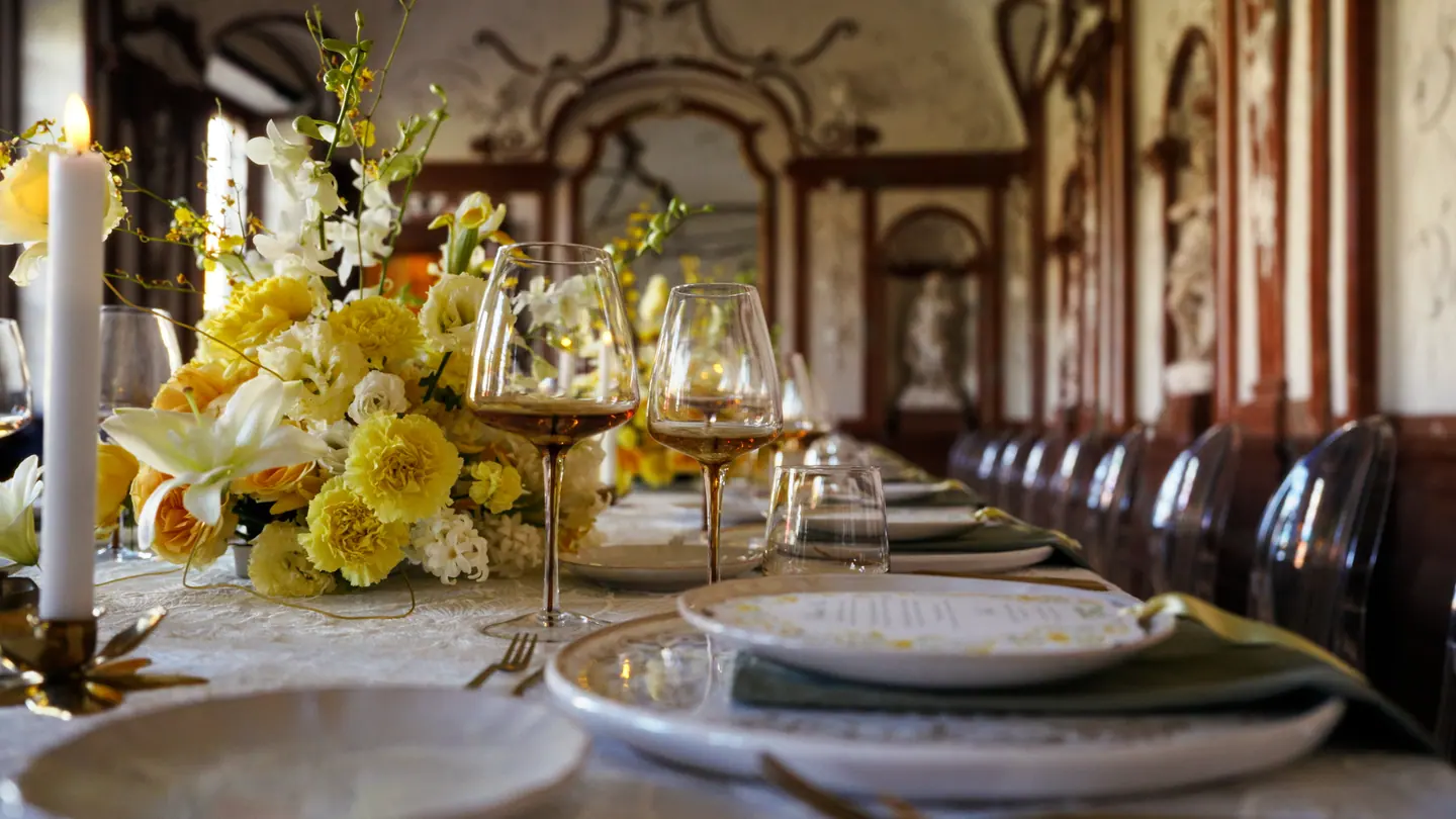 Close detail of florals, candles, and glassware on the table