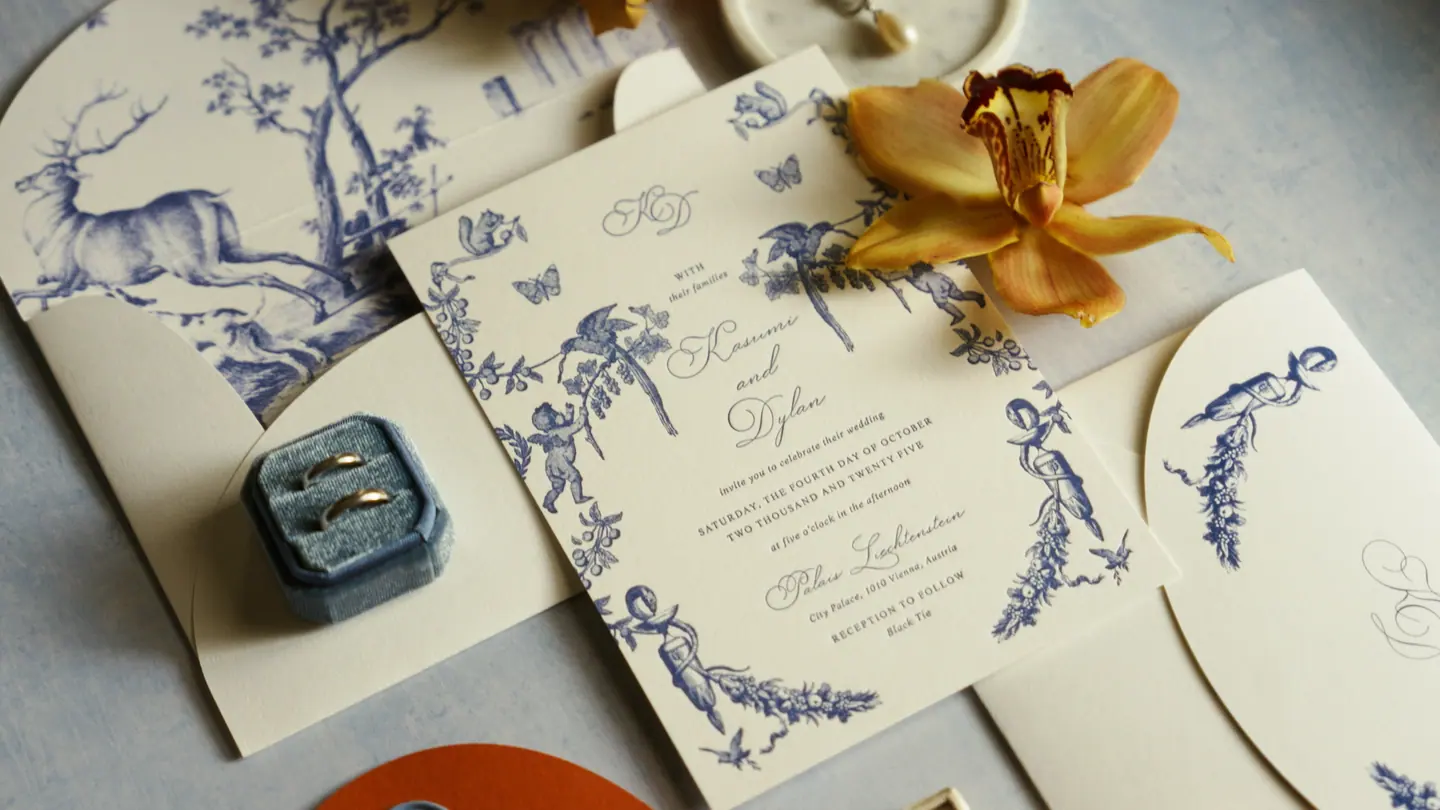 Blue and white wedding invitation suite with rings and orchid