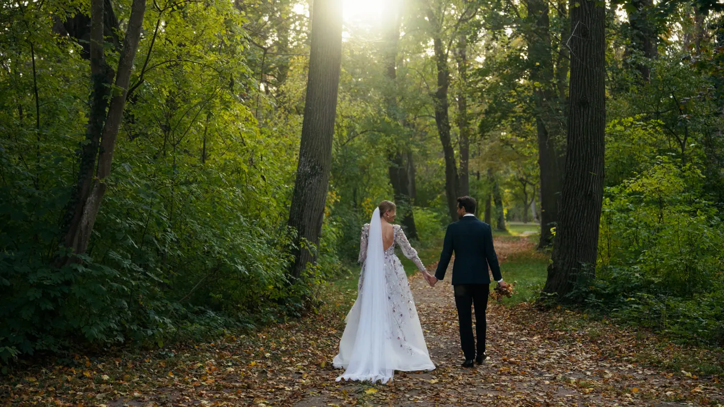 Bride and groom walking through Schlosspark Laxenburg