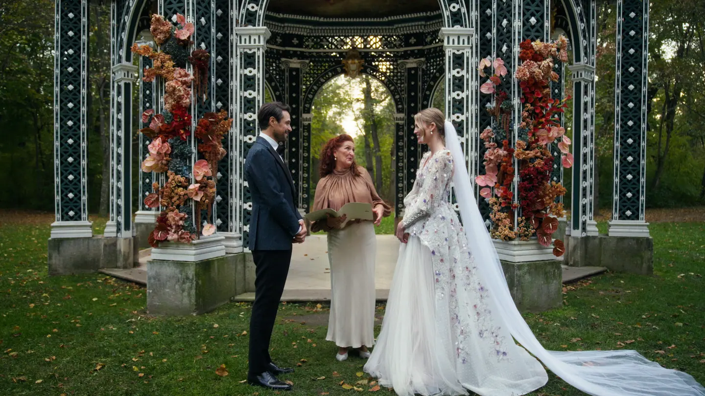Outdoor wedding ceremony beneath a filigree pavilion in Laxenburg